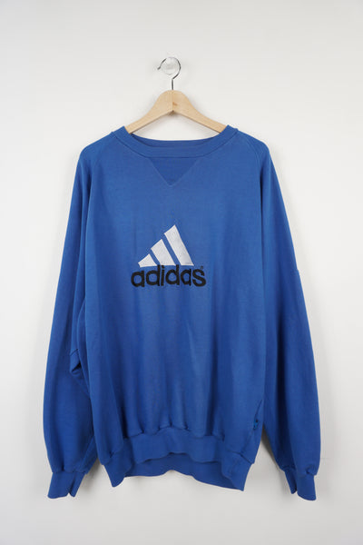 Adidas blue crewneck sweatshirt with embroidered spell-out logo, and badge on sleeve
