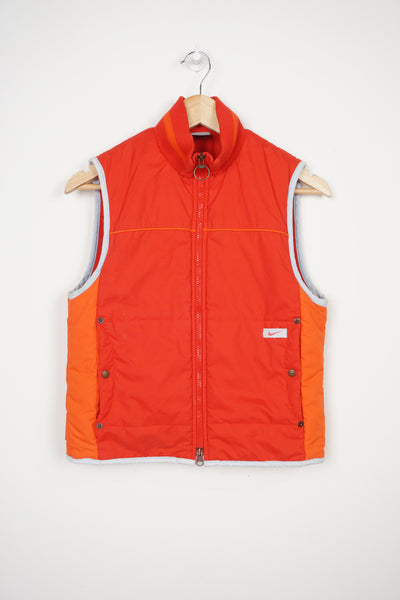 2000s all red Nike zip through padded gilet, with swoosh embroidered logo on the pocket