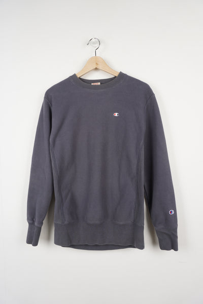 Grey crew neck Champion sweatshirt with small embroidered logo on the chest