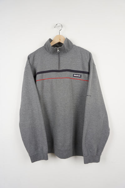 Reebok grey 1/4 zip sweatshirt with stripe detail on the front and rubber box logo