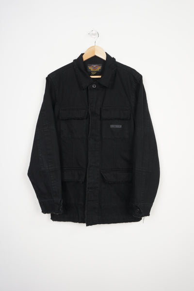All black Harley Davidson denim jacket with embroidered logo on the front pocket and frayed edge details