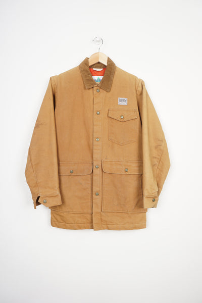 Vintage tan Liberty chore jacket with corduroy collar, multiple pockets and embroidered logo on the front