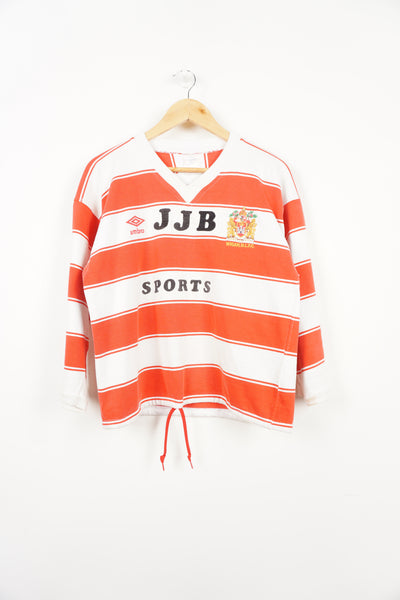 Vintage Umbro 1980's Wigan Rugby League red and white striped cotton jersey with embroidered badge, drawstring hem and raised sponsor