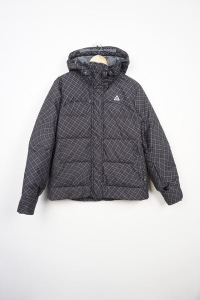 Black patterned Nike ACG puffer jacket with multiple pockets and embroidered logo on the chest