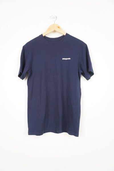 Patagonia navy blue t-shirt with printed spell-out logo on the front and signature mountain graphic on the back 