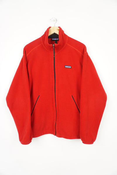 Patagonia all red zip through fleece with embroidered logo on chest and zip up pockets