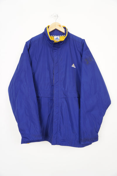 Vintage 90's blue Adidas coat with yellow quilted lining, embroidered logo on the chest and zip up pockets