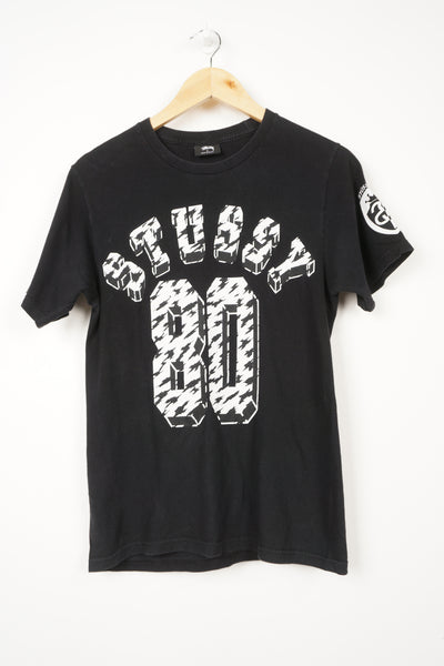 Black Stussy sport t-shirt with spell-out graphics on the front, back and sleeve