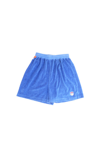 Blue Reebok training sports shorts with elasticated waistband and drawstring tie. Made from a velour toweling material. Features embroidered Reebok logo on the front leg.