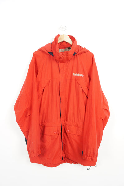 Timberland red zip through waterproof jacket with fold away hood and embroidered logo on the chest