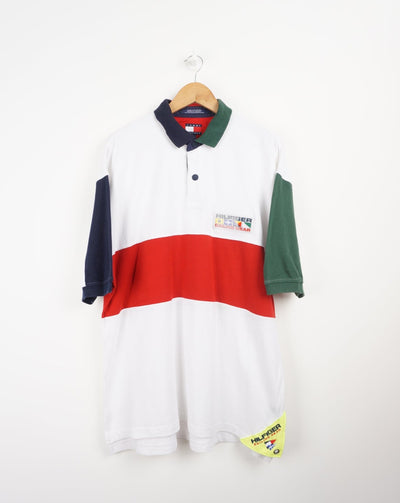 Tommy Hilfiger Sailing Gear white polo shirt with embroidered logo good condition Size in Label: L Our Measurements: Chest: 25 inchesLength: 30 inches Please ensure you check all measurements. ** All our items are pre-loved and as a result may show signs of wear due to the age of the product, for any questions about this or any other item please email hello@vintage-folk.com **