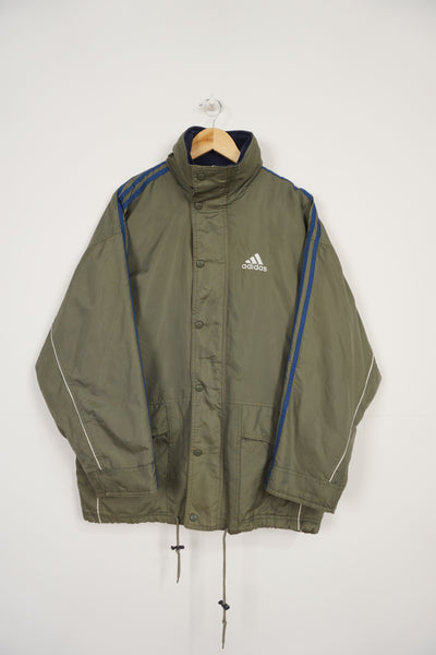 Vintage 90's khaki green Adidas padded sports coat, with embroidered logo on the chest, three stripes down the sleeve and foldaway hood