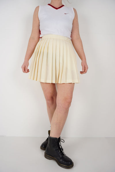 Vintage yellow pleated tennis skirt with embroidered logo near the hem good condition Size in label: 14 Our Measurements: Waist: 28 inchesLength: 16.5 inches Please ensure you check all measurements. ** All our items are pre-loved and as a result may show signs of wear due to the age of the product, for any questions about this or any other item please email hello@vintage-folk.com **&nbsp;