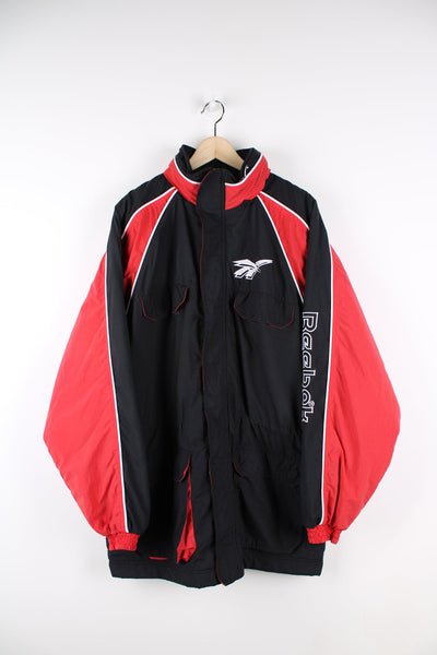 Black vintage Reebok coat. Features red panelling and embroidered logo on the chest and sleeve.
