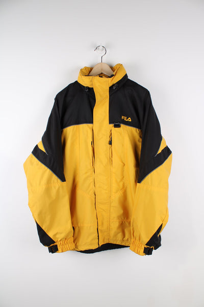 Yellow and black Fila coat. Features embroidered logo on the chest.