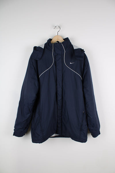 Blue Nike coat featuring embroidered logo on the chest and a packaway hood.