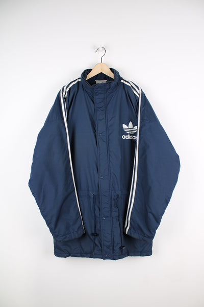 Blue Adidas coat featuring classic 3 stripes down the sleeves and printed logo on the chest and the back.