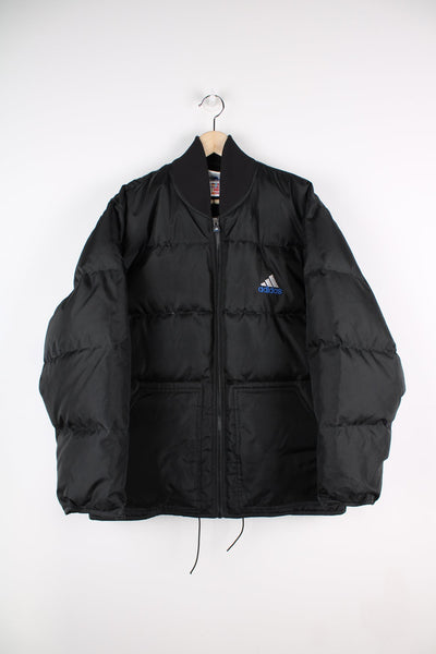 Black Adidas puffer coat with embroidered logo on the chest.