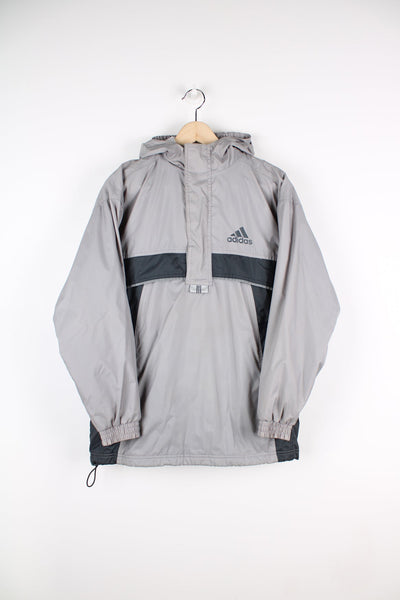 Grey and black Adidas pullover half zip jacket with fleece lining. Features printed logo on the chest.