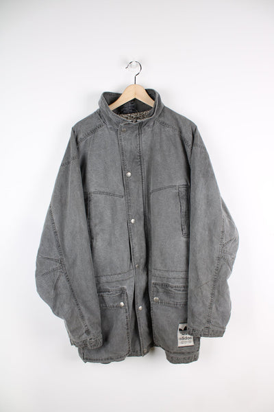 Adidas grey stonewash denim coat. Features embroidered logo on lower pocket.