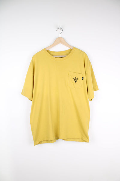 The North Face yellow T-Shirt featuring chest pocket with embroidered detail. 