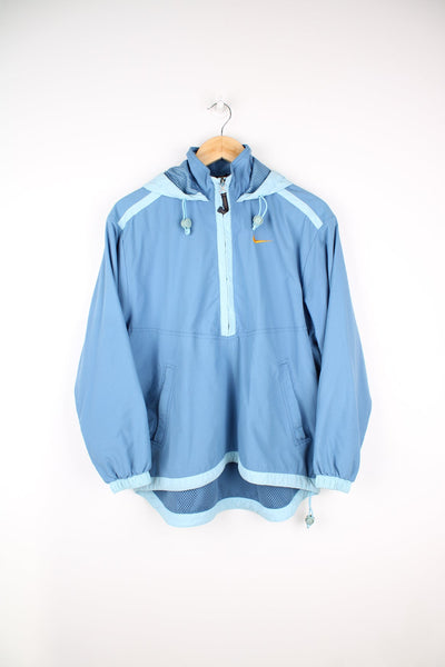 Blue Nike pullover tracksuit jacket with half zip. Features embroidered logo on the chest and back.