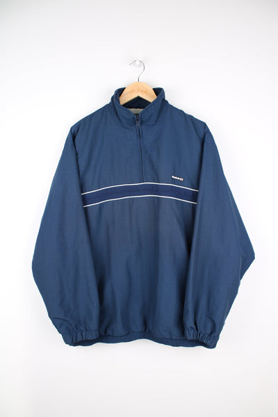 Blue Reebok pullover jacket with quarter zip and logo on the chest.