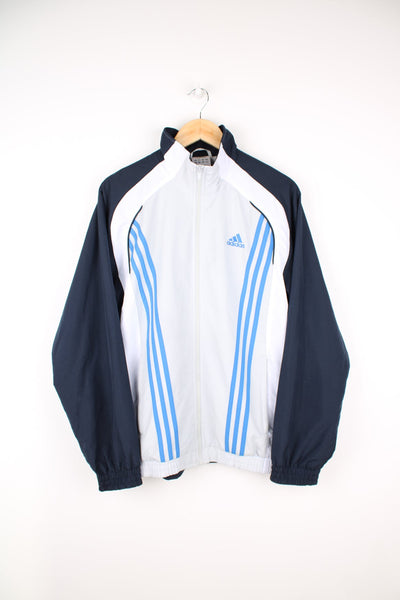 Adidas tracksuit top in blue, grey and white. Features embroidered logo on the chest and signature three stripe detail.