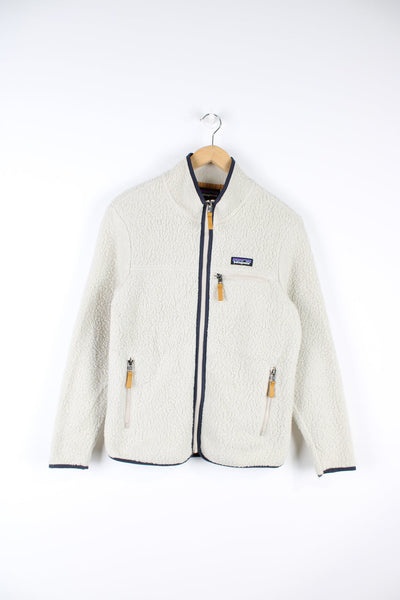 Beige Patagonia retro pile fleece. Features pocket on the chest and embroidered logo.