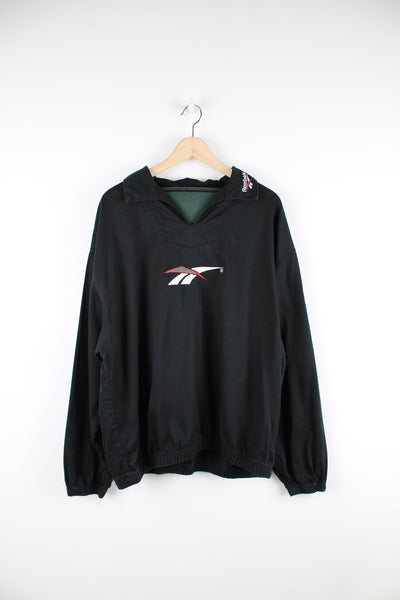 Vintage Reebok black pullover collared sweatshirt featuring embroidered logo across the chest.