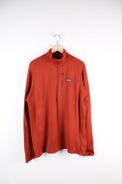 Orange Patagonia pullover waffle sweatshirt. Featuring half zip, embroidered logo and pocket on the chest. 