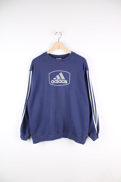 Vintage Adidas blue sweatshirt with embroidered logo across the chest and classic three stripes down the sleeves.