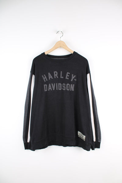 Vintage Harley Davidson black sweatshirt with grey spell-out logo across the chest and stripe feature down both sleeves.