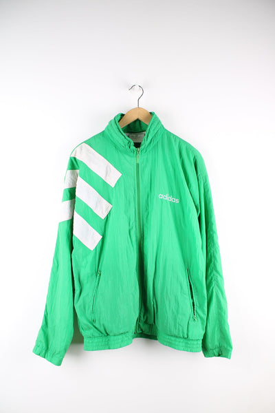 Vintage Adidas 80s green tracksuit top. Features embroidered logo on the chest, white panel detailing and a packaway hood.