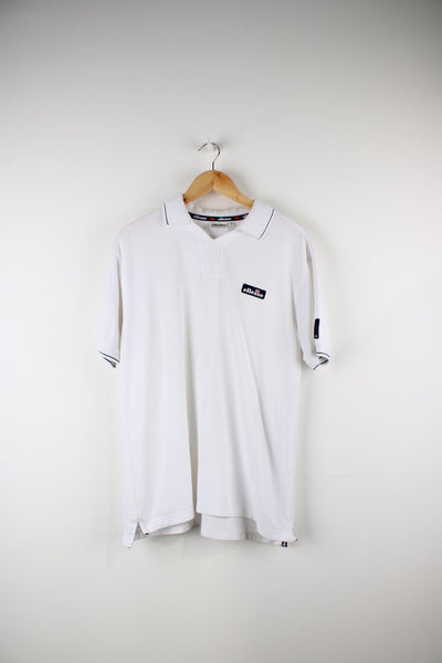 White Ellesse polo shirt with embroidered logo on the chest.