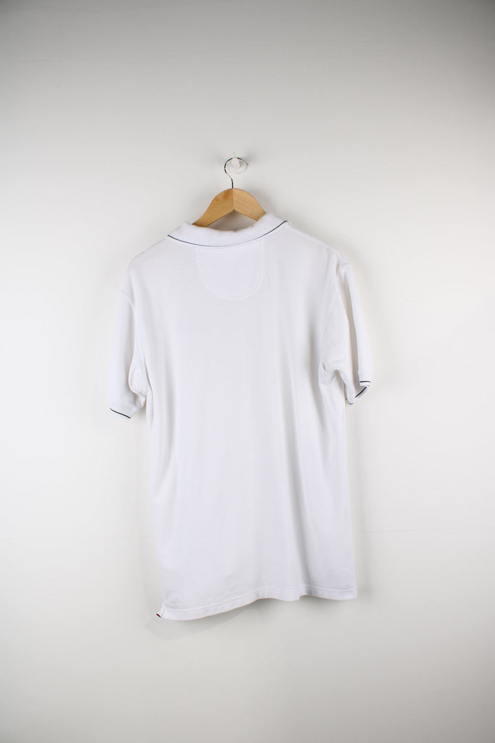 White Ellesse polo shirt with embroidered logo on the chest.