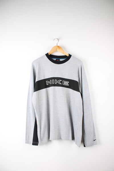 Nike long sleeve top in grey with printed logo across the chest and black panel detail.