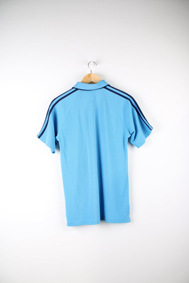 Vintage Adidas polo shirt with embroidered logo on the chest and signature three stripes on each sleeve.