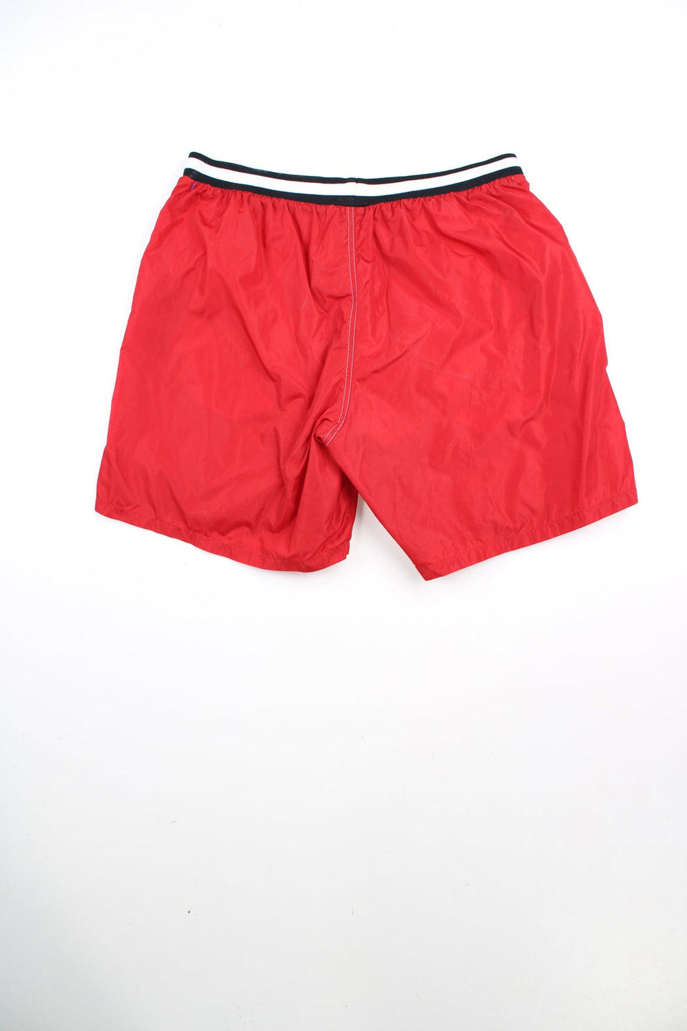Red Nike swim shorts with elasticated drawstring waist and embroidered logo. 