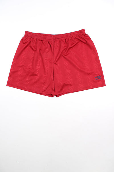Red Umbro shorts with elasticated waist and drawstring. Features embroidered logo. 