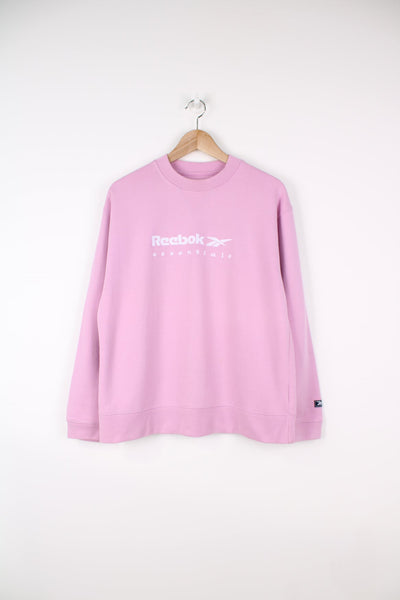 Pink Reebok sweatshirt with embroidered spell out logo across the chest.