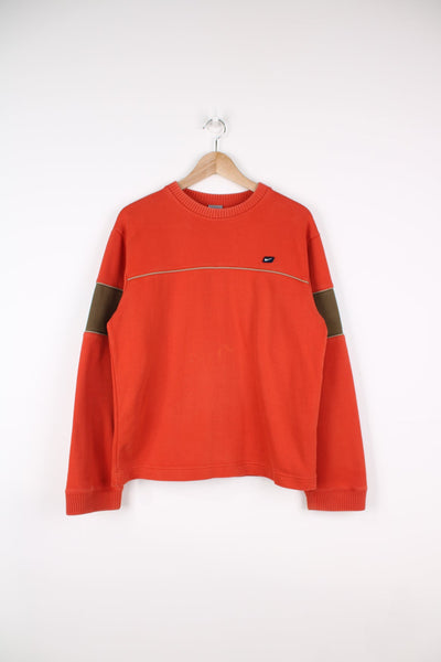 Vintage 00's orange nike sweatshirt. Features embroidered logo on the chest and brown panel details.