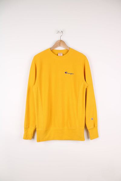 Champion Reverse Weave sweatshirt in yellow. Features embroidered logo on the chest.