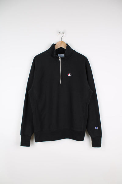Champion Reverse Weave half zip sweatshirt in black. Features embroidered logo on the chest.