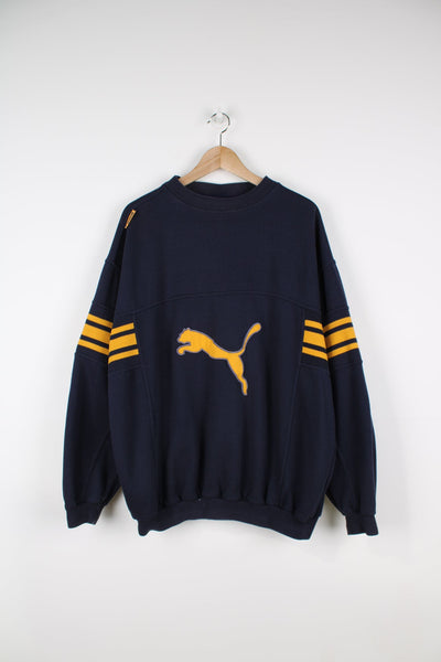Vintage Puma sweatshirt with embroidered logo on the front and yellow stripe detailing on the sleeves.