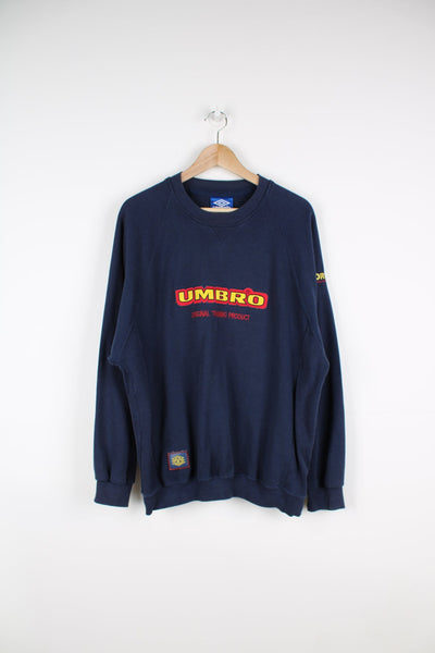 Vintage blue Umbro sweatshirt with yellow and red embroidered logo across the chest.