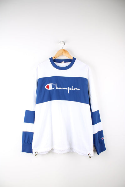Blue and white Champion pullover tracksuit top. Features embroidered logo across the chest.