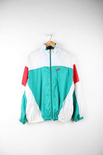 Vintage Nike International tracksuit top in white green and red. Features embroidered logo on the chest and badge on the sleeve.