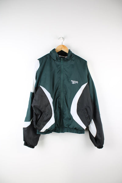 Vintage Reebok tracksuit top in green, black and white. Features embroidered logo on the chest and back.