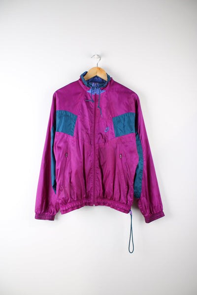 Vintage 80s purple Nike tracksuit top. Features panel details and embroidered logo on the chest.
